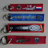 embroidered remove before flight key chains